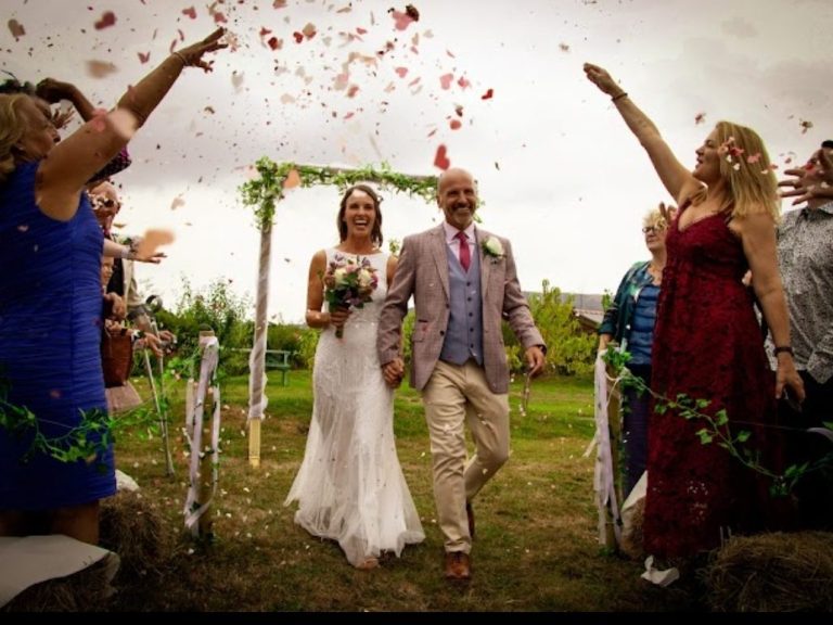 Just married couple having confetti thrown over them