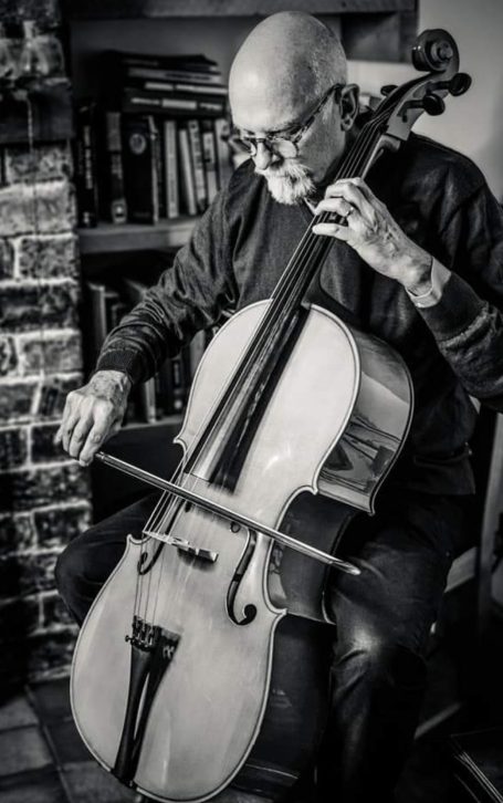 Older man with beard playing the cello