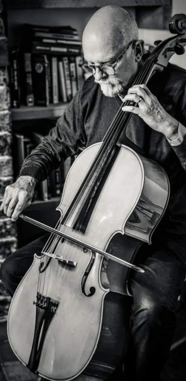 Black and white image of older man playing the cello