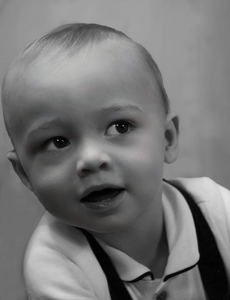 Young male child in black and white smiling