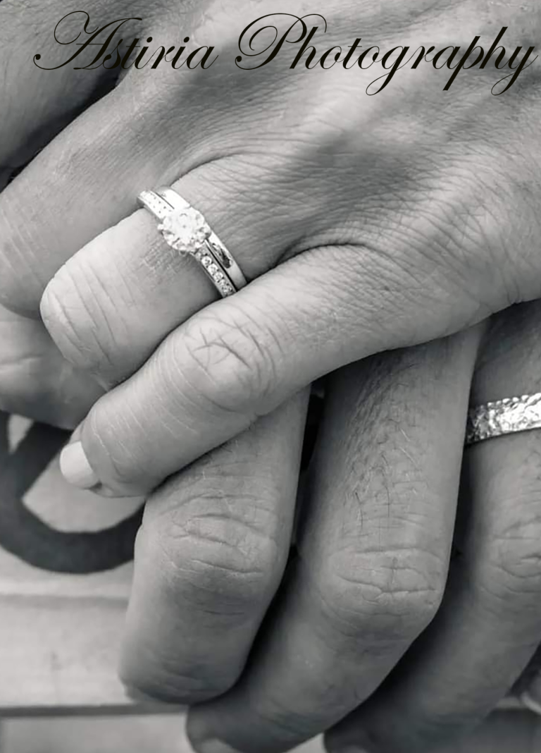 Close up of wedding rings as newly married couple hold hands