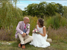 Nwely married couple sat by a pond